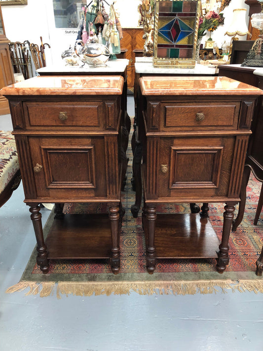A matched pair of French oak marble topped bedsides. Comprising one drawer and one cupboard.