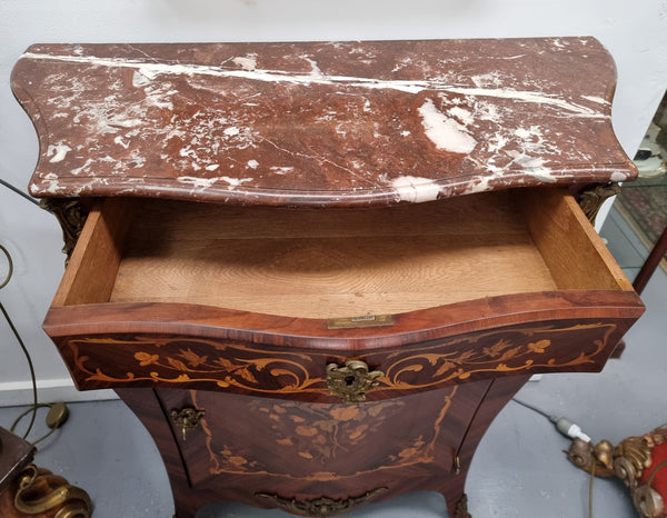 Stunning French Transitional style Mahogany marquetry inlay salon cabinet in the bombe shape. It has one draw, one shelf, marble top & ormolu decoration. Sourced from France and in good original detailed condition.
