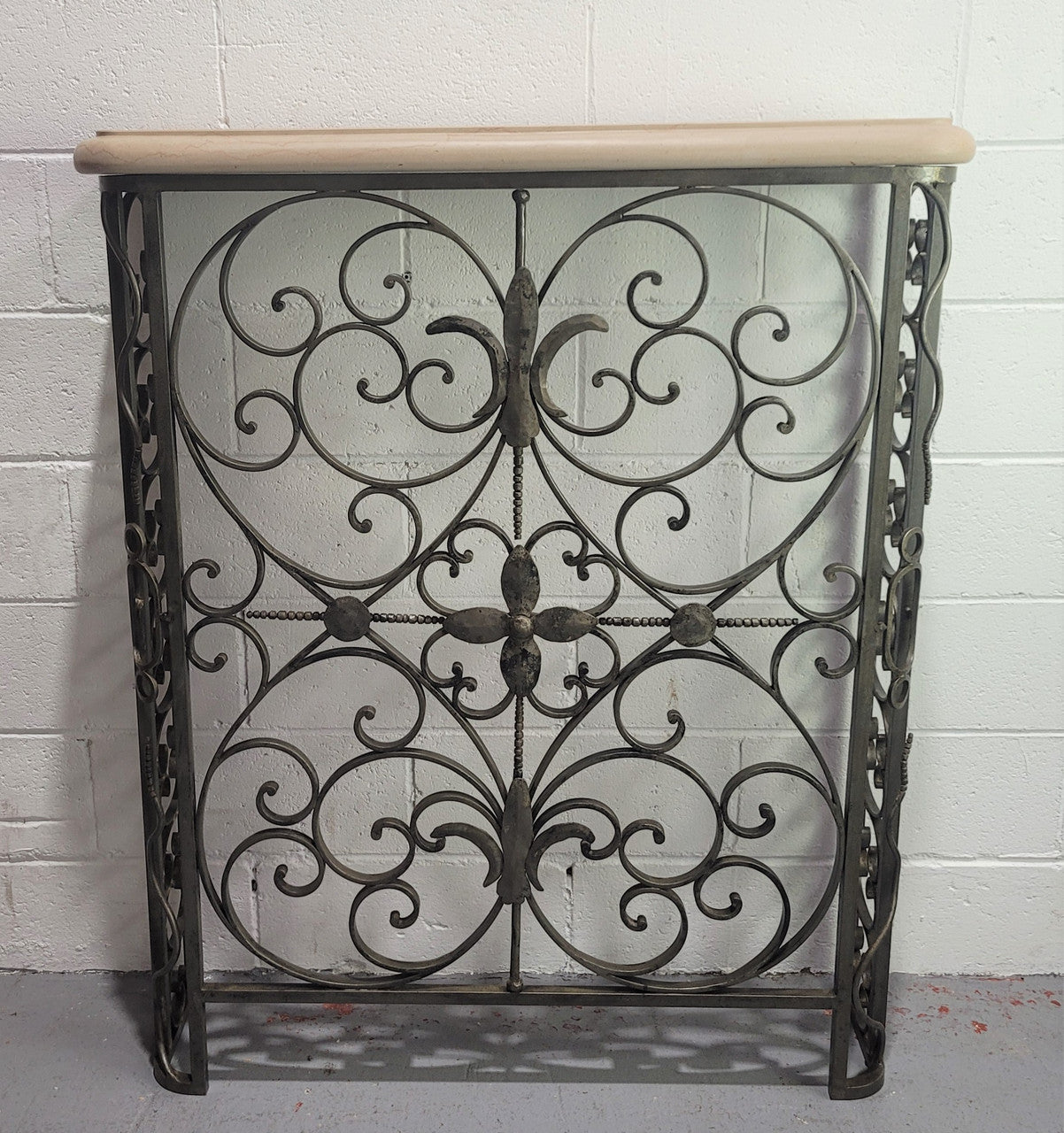Stunning Art Deco wrought iron and marble top console table. It has amazing decorative iron work at the bottom and a beautiful marble top. It is in good original detailed condition.