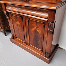 Mid 19th Century Australian Cedar and Flame Cedar tall bookcase. The top has two glass doors that open up to three adjustable shelves followed by a drawer in the middle and finishes with two beautiful wooden doors that open up to a fixed shelf. In good original detailed condition and has been sourced locally.