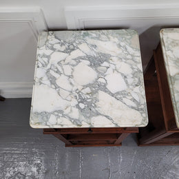 Pair of Antique French Oak Louis XVI style marble top bedside cabinets. They have decorative inlay and have been sourced from France. They are in good original detailed condition.