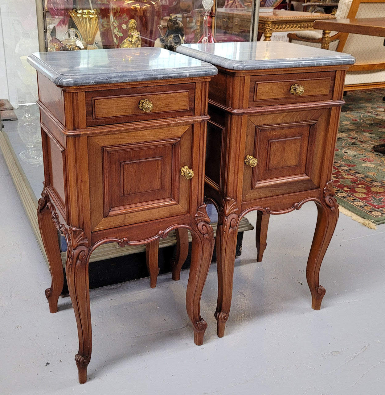 Pair of Walnut Louis XV style grey marble top bedside cabinets. Single drawer, one cupboard and lovely French cabriole legs. They have been sourced from France and are in good original condition.