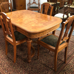 Lovely carved French Oak dining table with a parquetry top and six matching upholstered chairs in good original detailed condition.