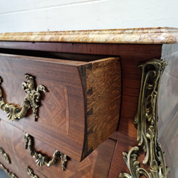 A beautifully inlaid parquetry three drawer commode with a lovely marble top, and decorative ormolu mounts. In good original detailed condition. Circa 1930