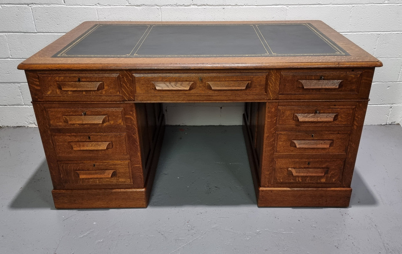 Amazing American Oak full partners leather top desk. Plenty of storage space with nine drawers on one side and two cupboards of the oppsite side. It is in good restored condition and has a new leather and gold tooled inset top.