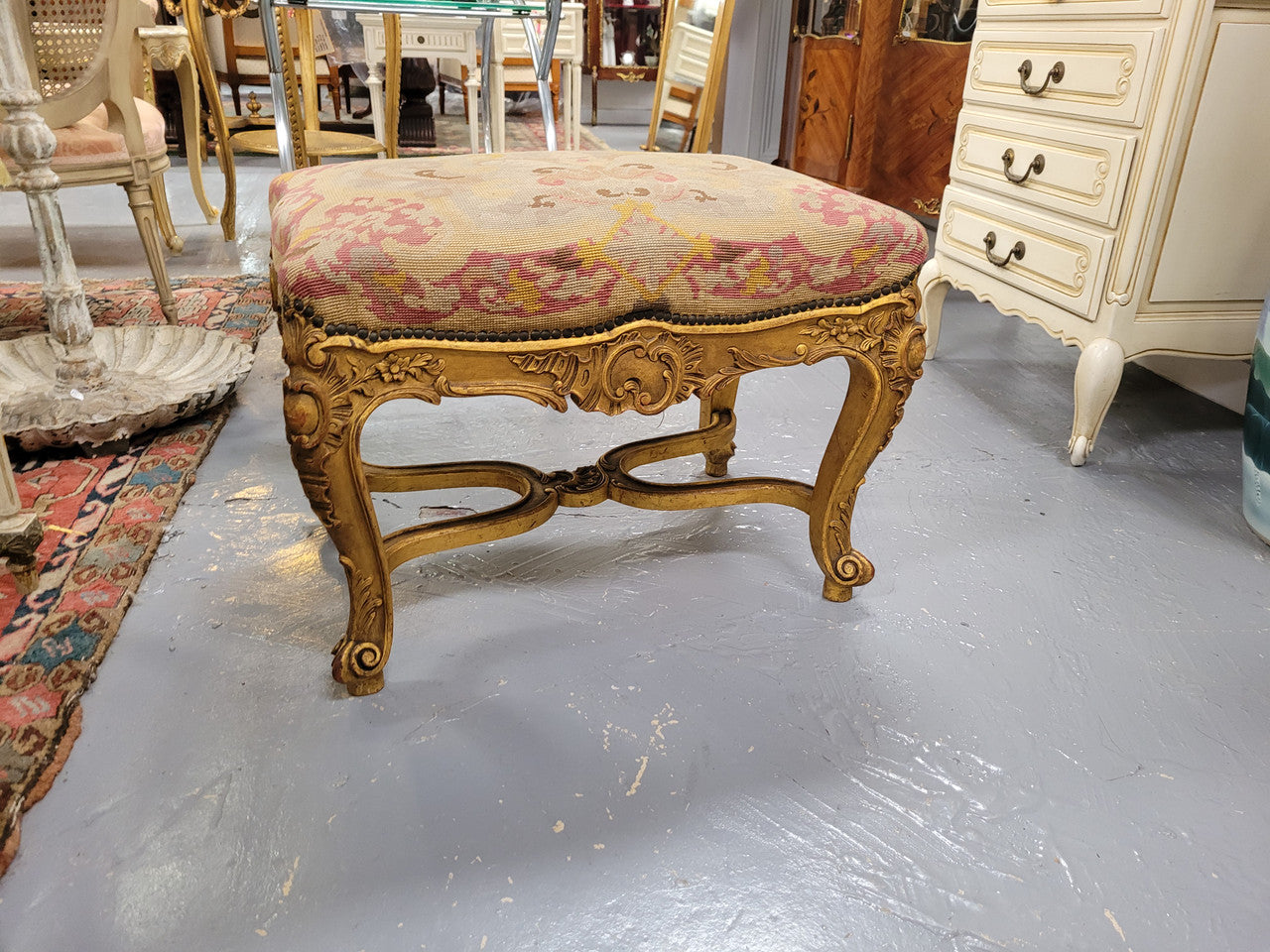 Charming 19th Century gilt wood tapestry covered Louis XV style stool. It has a beautifully carved base and undercarriage and it has been sourced from France. It is in good original detailed condition, please view photos of tapestry has they help form part of the description.