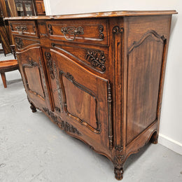 Attractive French Walnut Louis XV style two door two drawer sideboard featuring beautiful carving.  Circa: 1930's. It has been sourced from France and it is in good original detailed condition.