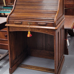 Charming petite English Oak fitted roll top desk. It has a very lovely fitted interior and a drawer at the front ideal for a unit or apartment. Sourced locally and in good original detailed condition.