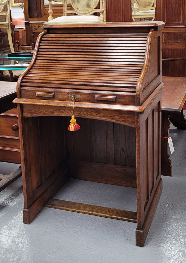 Charming petite English Oak fitted roll top desk. It has a very lovely fitted interior and a drawer at the front ideal for a unit or apartment. Sourced locally and in good original detailed condition.