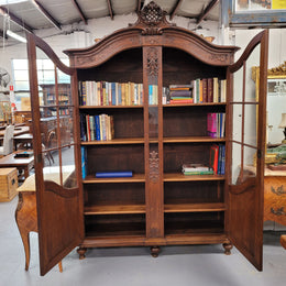 Substantial French Oak Louis 15th Style large two door bookcase. Adjustable shelves and very decorative carving. In good original detailed condition.