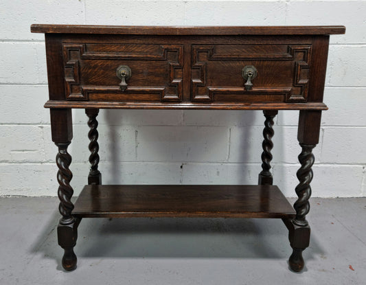 Lovely dark oak small Jacobean style two drawer side cabinet with barly twist legs and lovely carved details. In good original detailed condition.