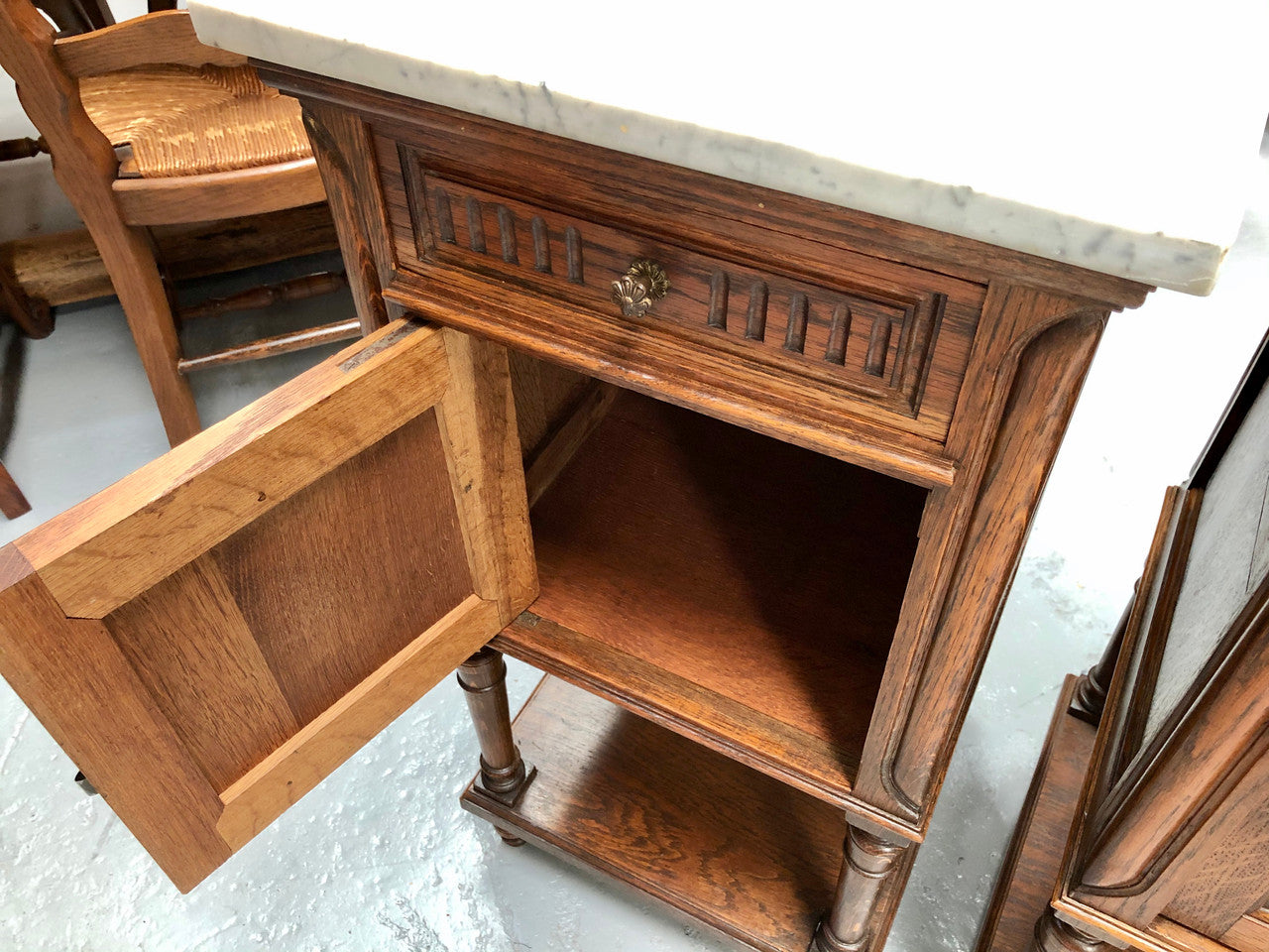 A french oak pair of carved bedside cabinets, with lovely detail and nice coloured marble tops and plenty of storage space. In good condition.