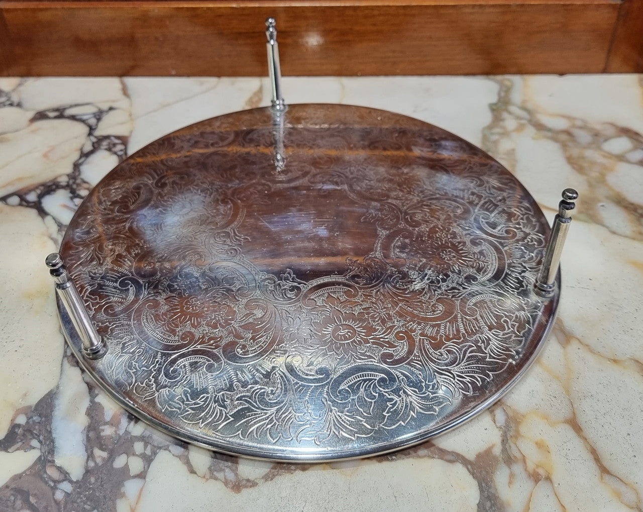Five Strachan and two Rodd silver plate table coasters in a silver plate stand. In good original detailed condition.