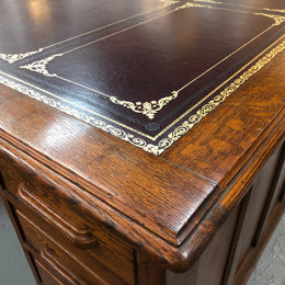 Lovely large English oak partners desk, with a beautiful burgundy tooled leather top. Plenty of storage space, both sides have 9 functioning drawers. It is in very good condition.