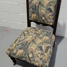 Single upholstered Edwardian nursing chair. Fabric is in good original used condition and chair has four caster wheels and is in good original condition.