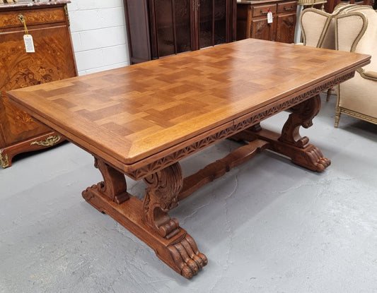 Amazing French Oak Renaissance style parquetry top extension table. Beautiful parquetry top and amazing detailed carvings on the legs. It extends to 306 cm long when fully extended. Sourced from France and in good original detailed condition.