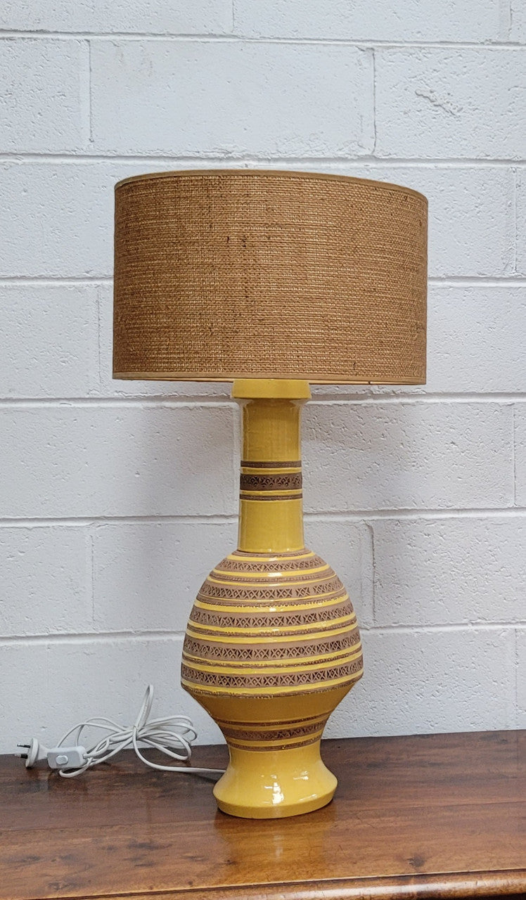 A large and impressive Vintage Mid-Century Bitossi Italian terra cotta lamp base and shade. Incised repeating geometric terra cotta pattern creates a tactile element which is incorporated with stunning shining thick yellow glaze to create the sculptural form of the base.