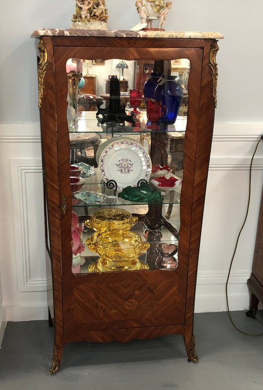 A Louis XV style Kingwood vitrine with marble top. It has beautifully floral inlay with ormolu mounts.