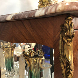 A Louis XV style Kingwood vitrine with marble top. It has beautifully floral inlay with ormolu mounts.