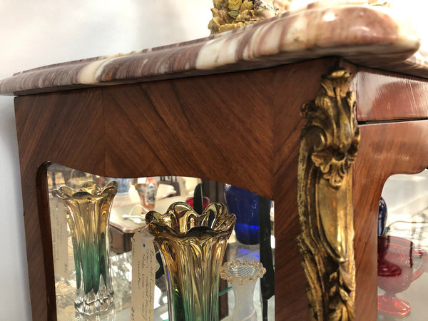 A Louis XV style Kingwood vitrine with marble top. It has beautifully floral inlay with ormolu mounts.