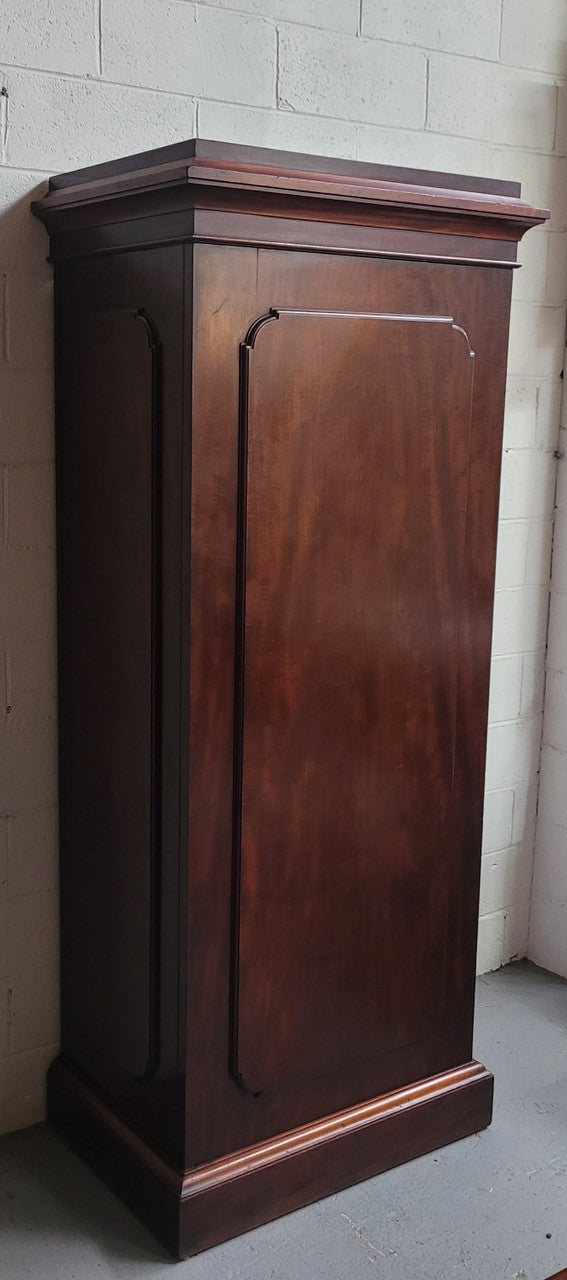 Unusual Victorian Flame Mahogany side wardrobe with side door. It has full hanging and six hooks. The wardrobe opens from a side door which can be locked with its key and has a markers mark stamp on the door. It is in good original condition.