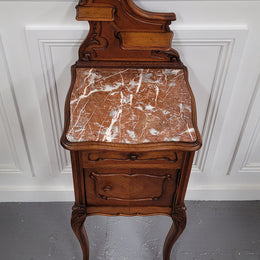 French Louis XV style Walnut single bedside cupboard with inset marble top. It has been sourced from France and is in good original detailed condition.