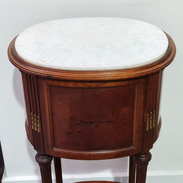 Round Louis XVI style Mahogany marble top side table. It has one drawer and a cupboard for storage. It is in good original detailed condition.