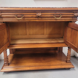 Stunning Henry II style French Walnut marble top buffet. It has a beautiful marble top and plenty of storage with two drawers, two doors with beautiful decorative carvings and an open shelf. It has been sourced from France and is in good original condition and has been detailed to a high standard.