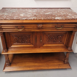 Stunning Henry II style French Walnut marble top buffet. It has a beautiful marble top and plenty of storage with two drawers, two doors with beautiful decorative carvings and an open shelf. It has been sourced from France and is in good original condition and has been detailed to a high standard.