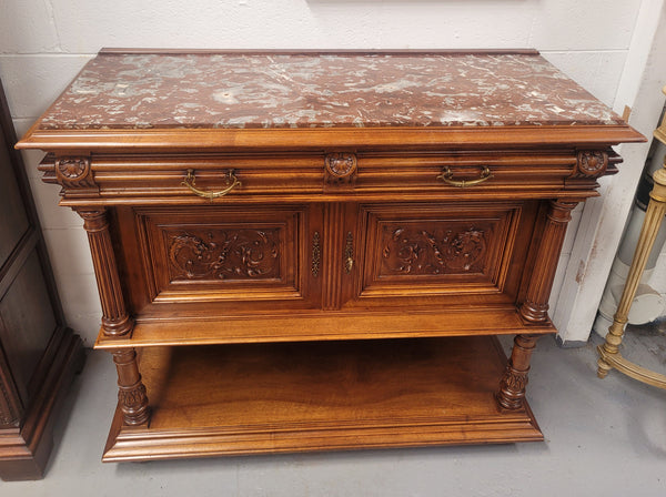 Stunning Henry II style French Walnut marble top buffet. It has a beautiful marble top and plenty of storage with two drawers, two doors with beautiful decorative carvings and an open shelf. It has been sourced from France and is in good original condition and has been detailed to a high standard.