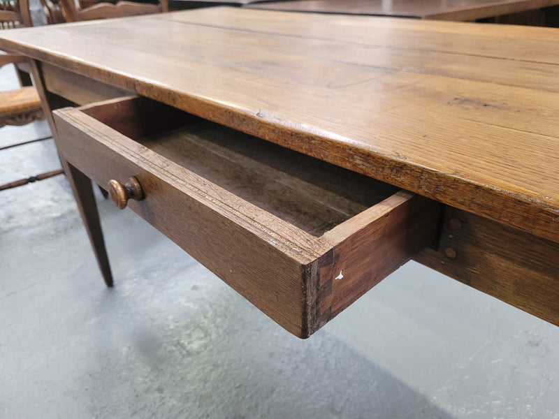 Provincial 19th Century French Oak rustic farmhouse table with tapered leg and single drawer. It has been sourced from France and is in good original detailed condition. 