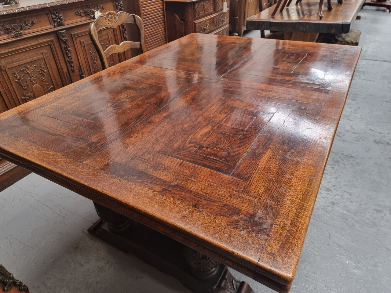 Renaissance style Oak extension table with parquetry top and twin pedestal base. The table extends by pulling out an extension leaf either side making it 287 cm long. Sourced from France and in good original detailed condition.