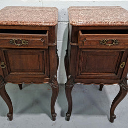 Stunning pair of French dark Oak bedside cabinets with a beautiful coloured marble top. They have one drawer and cupboard. They are in good original detailed condition.