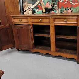 French Oak early 19th century three door buffet. It has a classic simple look and has three cupboards and three drawers. It is in good original detailed condition.