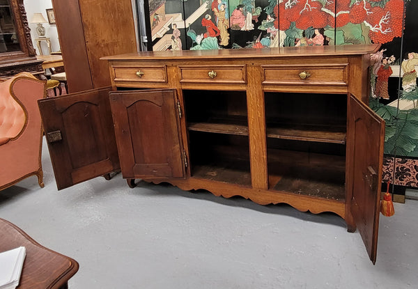 French Oak early 19th century three door buffet. It has a classic simple look and has three cupboards and three drawers. It is in good original detailed condition.
