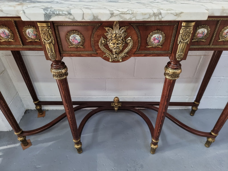 Vintage Mahogany marble top console table with matching mirror. Both with inset limoge panels surrounded by gilt brass. Highly decorative and in good original detailed condition. Circa 1950.
