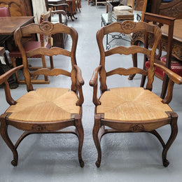 Pair of Louis XV Style Oak framed rush seated carver chairs. They have been sourced from France and in good original detailed condition.