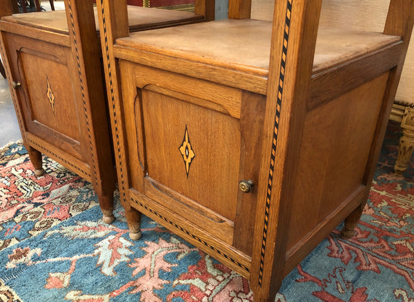 Beautiful pair of French Oak inlaid bedside cabinets with marble tops and a drawer and cupboard for all your storage needs in good original condition.