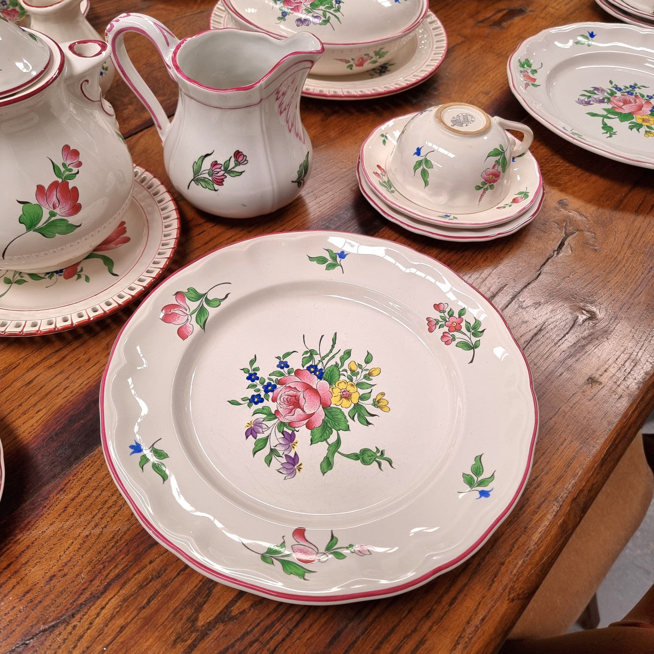 A pretty French table setting made in France called Luneville. It consists of plates, cups, saucers, tea pot, milk jug, sugar bowl, tureens and cake plates a total of 53 pieces. Please view photos as they help form part of the descriptions.