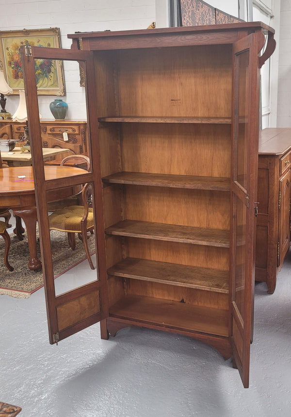 Beautiful two door Blackwood bookcase with glass doors and with four fully adjustable shelves. It is in good original detailed condition.
