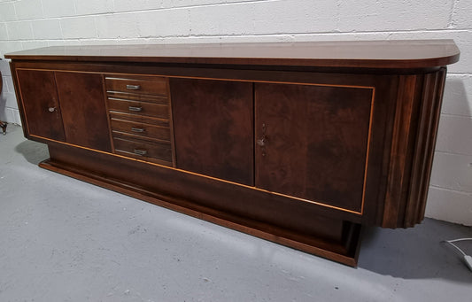 Amazing French Walnut Art deco four door buffet. The doors either side open to a fixed shelf and plenty of added storage with four drawers. In good original detailed condition.