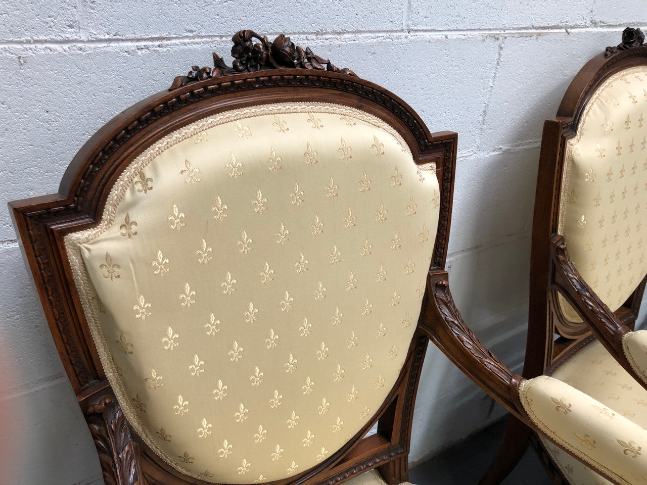 Beautiful pair of Vintage French Walnut Louis XVI style carved Fauteuils with lovely upholstery and wide seats . In good original detailed condition.