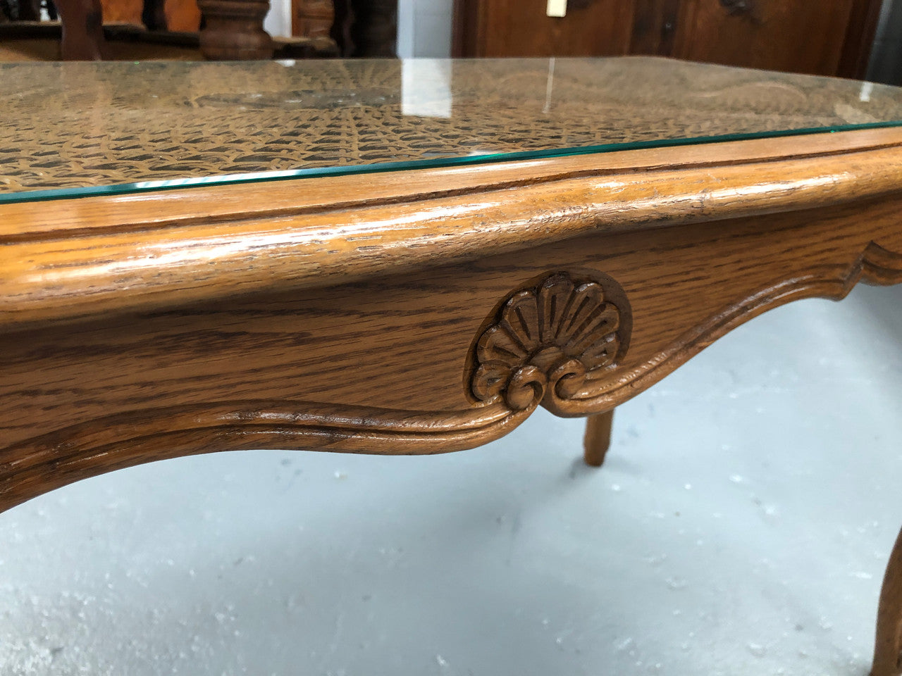 Lovely French Oak Louis XV style cane top coffee table with a glass top. In good original detailed condition.
