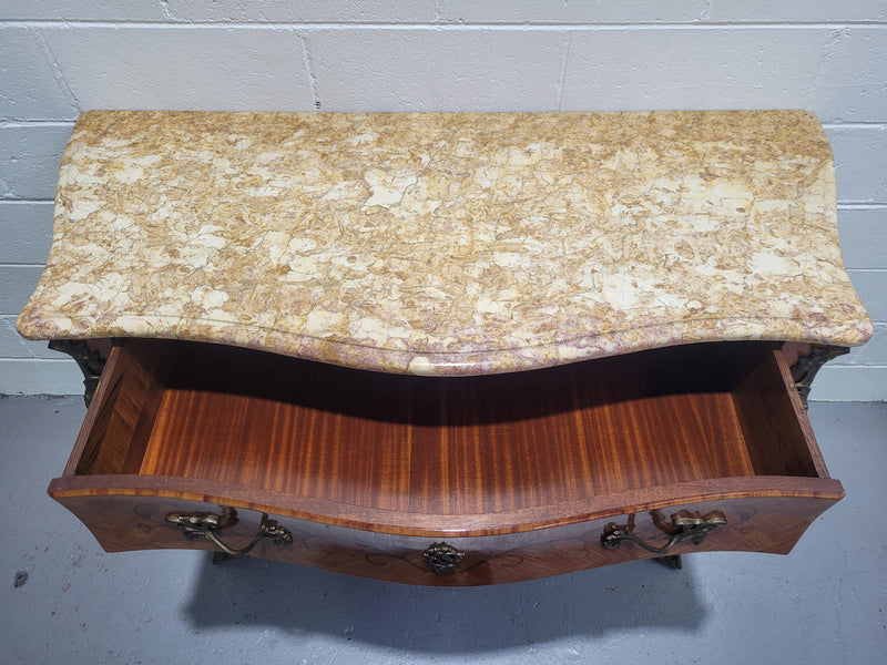 French three drawer marquetry inlaid marble top commode with decorative ormolu mounts. In good original detailed condition.