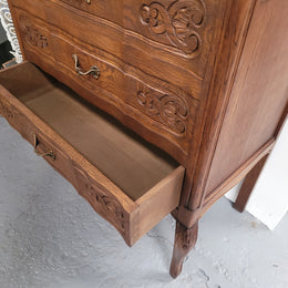 French Oak Louis XV style three drawer commode. It has been sourced from France and has decorative handles and carvings. It is in good original detailed condition.