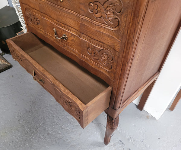 French Oak Louis XV style three drawer commode. It has been sourced from France and has decorative handles and carvings. It is in good original detailed condition.