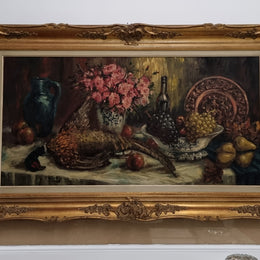 Sourced from France is this beautiful large oil on canvas of fruit flowers and a pheasant in a decorative guilt frame and signed . In good original condition.