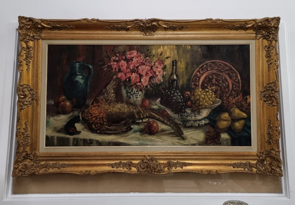 Sourced from France is this beautiful large oil on canvas of fruit flowers and a pheasant in a decorative guilt frame and signed . In good original condition.