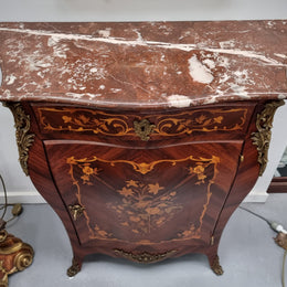 Stunning French Transitional style Mahogany marquetry inlay salon cabinet in the bombe shape. It has one draw, one shelf, marble top & ormolu decoration. Sourced from France and in good original detailed condition.
