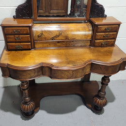 An elegant Victorian Figured Walnut dressing table with tilit mirror and a stunning fine Firgured Walnut serpentine shaped front. It has been sourced locally and is in good original detailed condition.